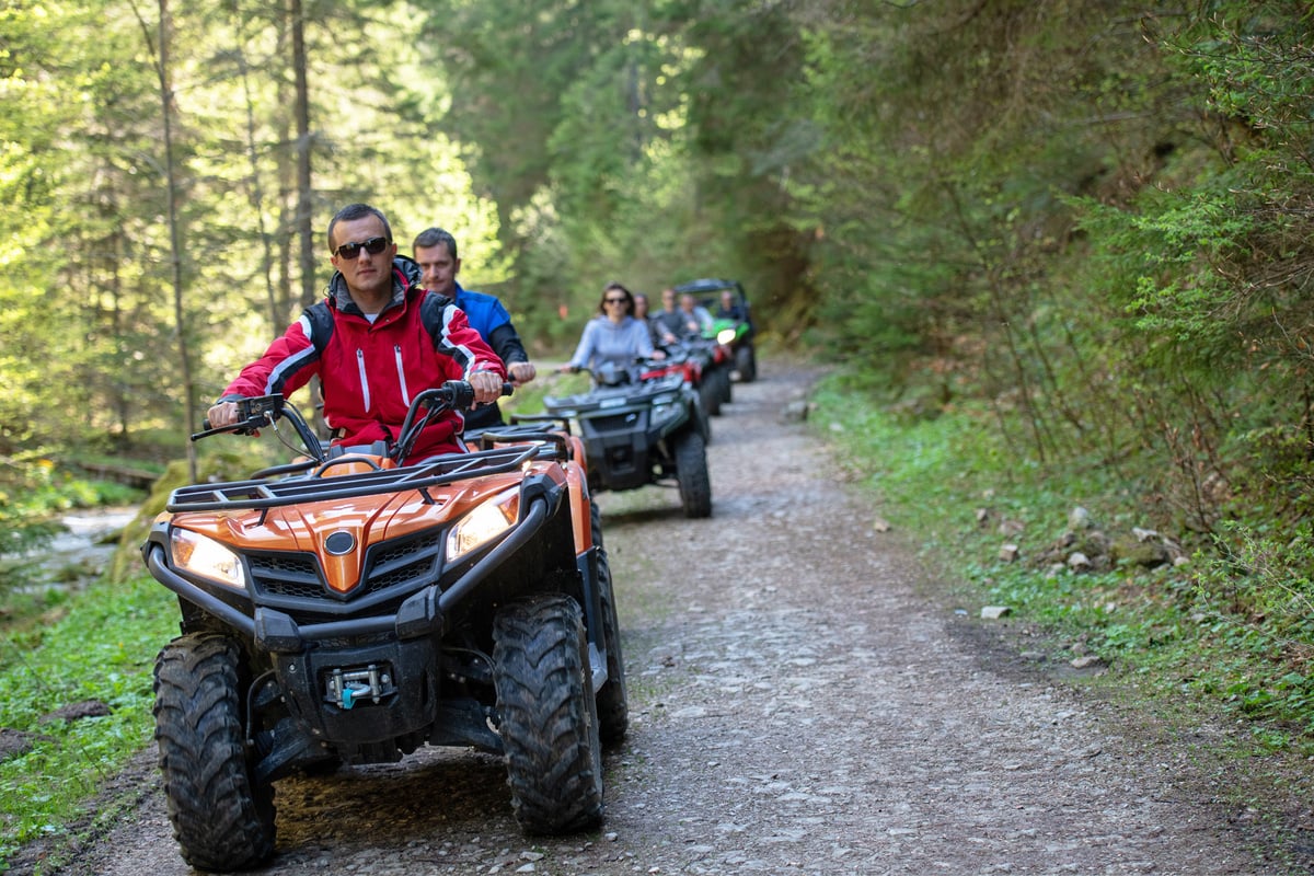 man riding atv vehicle on off road track ,people outdoor sport activities theme